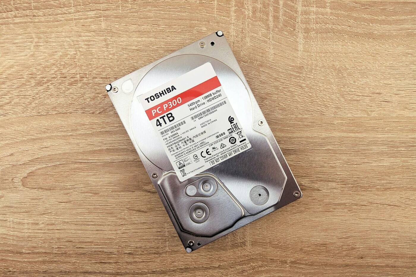 A 4 TB hard drive lying on a wooden desk